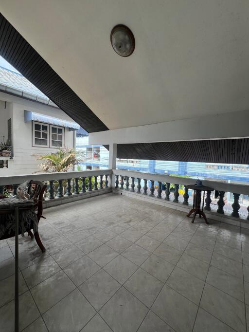 Spacious balcony with tiled floor and railings