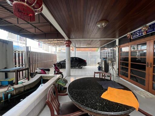 Covered outdoor patio with parking space