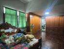 Spacious bedroom with wooden furniture and large windows