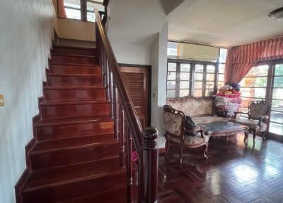 Cozy living space with wooden staircase and furniture