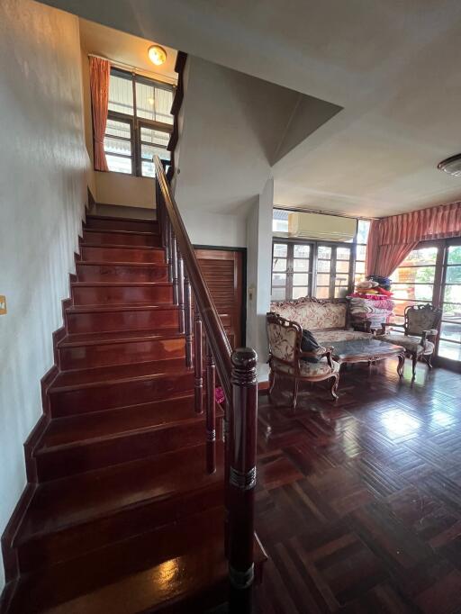 Cozy living space with wooden staircase and furniture