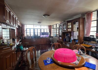 Dining room with wooden furniture and large windows