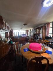 Dining room with wooden furniture and large windows