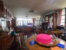 Dining room with wooden furniture and large windows