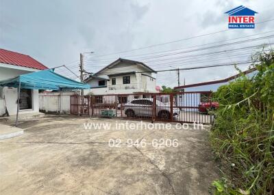 Gated driveway with surrounding buildings