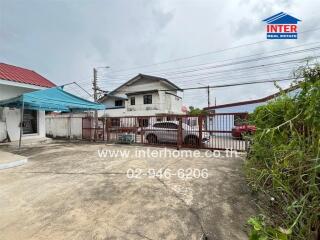 Gated driveway with surrounding buildings