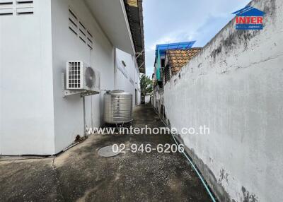 Side alley with building and air conditioning unit