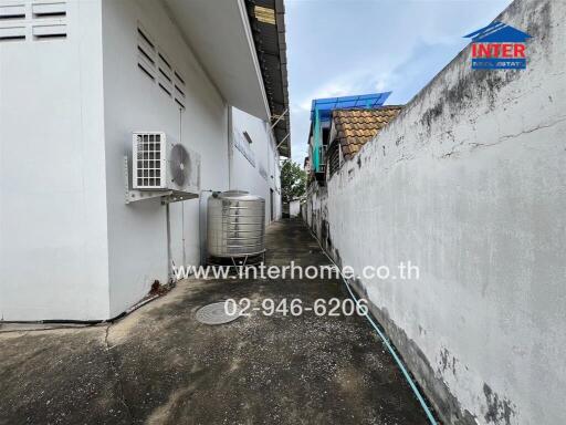 Side alley with building and air conditioning unit