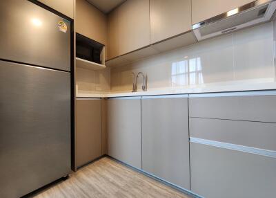 Modern kitchen with stainless steel appliances and beige cabinetry