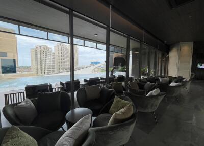 Modern lounge area with city view and swimming pool