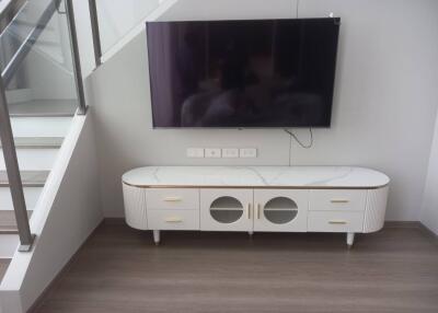 Modern living room with mounted TV and stylish cabinet