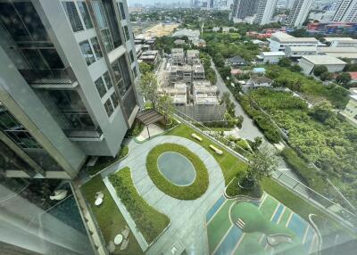 Arial view of building exterior with green landscape