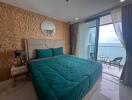 Bedroom with large bed, ocean view, and balcony access