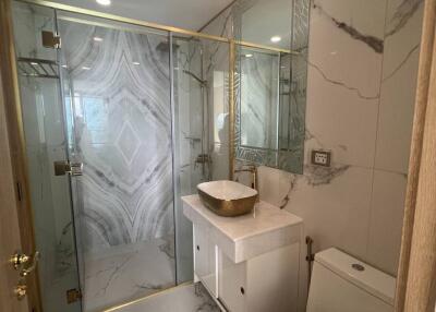 Modern bathroom with glass shower and marble tiles