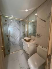 Modern bathroom with glass shower and marble tiles