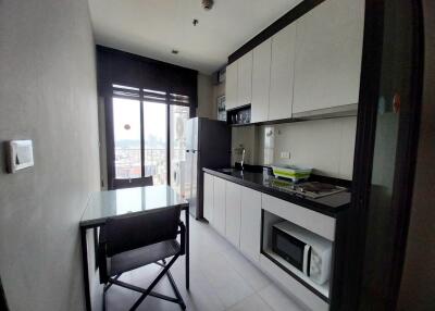 Modern kitchen with built-in appliances and dining area