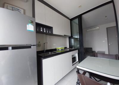 Modern kitchen area with adjacent living space