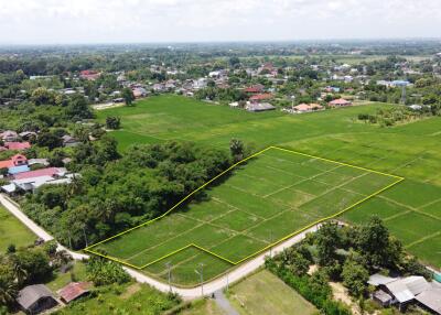 Aerial view of a plot of land marked with a yellow boundary