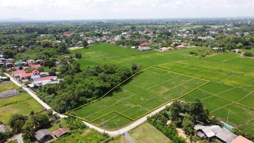 Aerial view of a plot of land marked with a yellow boundary