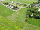 Aerial view of a large plot of land surrounded by greenery.