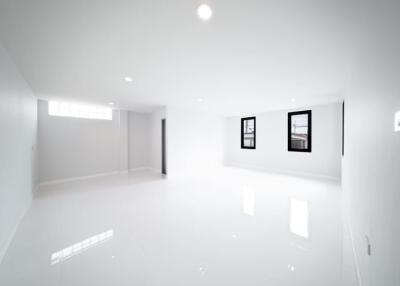 Bright and spacious white living room with large windows