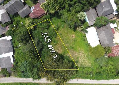 aerial view of a plot of land measuring 145 square wa with surrounding buildings and greenery