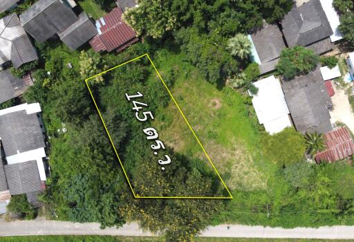 aerial view of a plot of land measuring 145 square wa with surrounding buildings and greenery