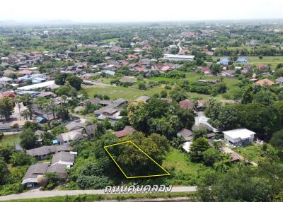 Aerial view of a residential area with available plot marked