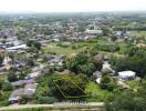 Aerial view of a residential area with available plot marked