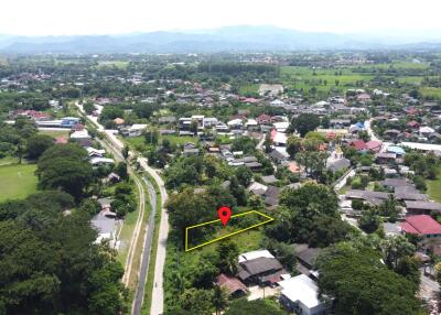 Aerial view of a neighborhood with marked plot