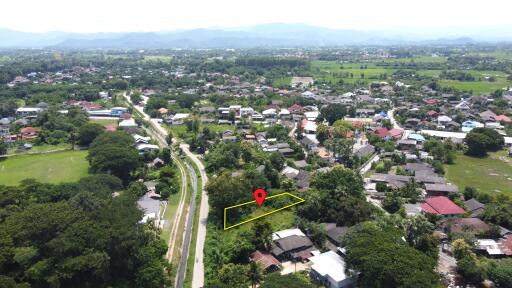 Aerial view of a neighborhood with marked plot