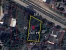 Aerial view of a land plot with measurements and boundaries