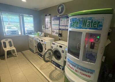 Laundry room with washing machines and water dispenser