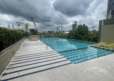 Outdoor swimming pool with surrounding pavement