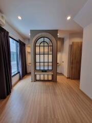 Modern living space with wooden flooring and large window