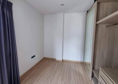 Empty bedroom with wooden flooring and built-in wardrobe