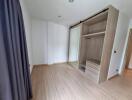 Bedroom with wooden floor and built-in closet