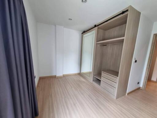 Bedroom with wooden floor and built-in closet