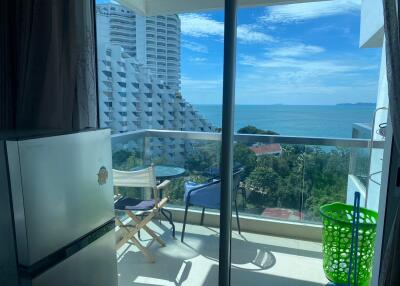 Balcony with a view of the ocean and nearby buildings