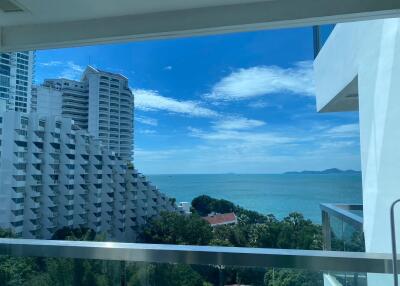 Balcony with ocean view and modern apartment buildings