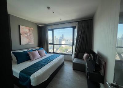 Modern bedroom with large window and city view