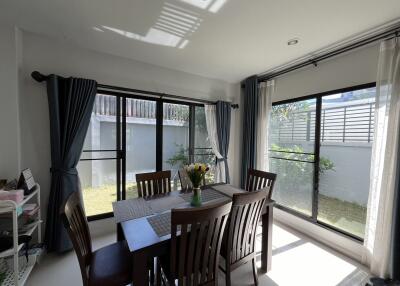 Dining area with large windows and garden view