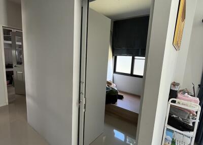 Interior view of an apartment hallway leading to a room