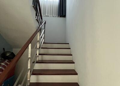 Modern staircase with wooden steps and metal railings