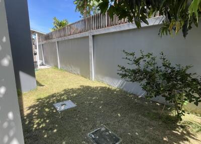 Outdoor space with lawn and boundary walls