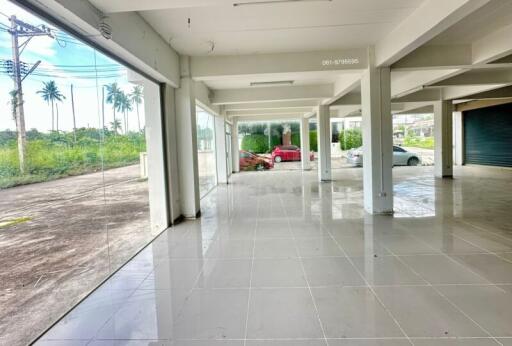 Spacious empty commercial building with large glass windows