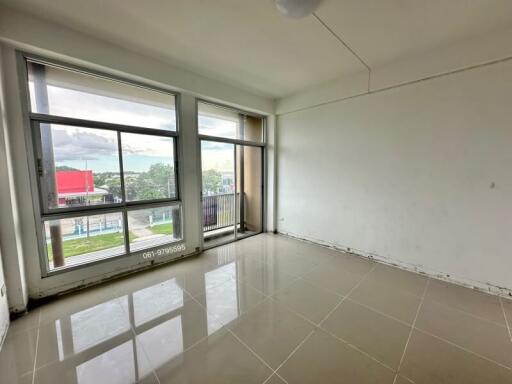 empty bedroom with large windows and tiled floor