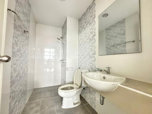 Modern bathroom with tiled walls and fixtures