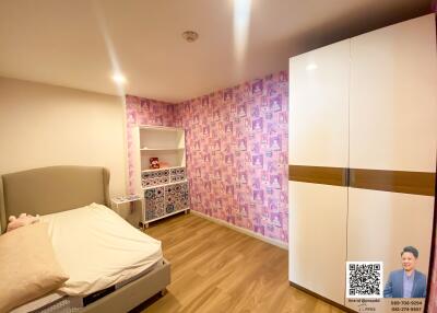 Modern bedroom with patterned accent wall and wardrobe