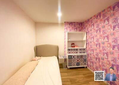 Bedroom with pink wallpaper and stuffed toys